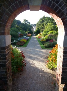 The early morning sun starts to light up the Summer Borders at Nymans